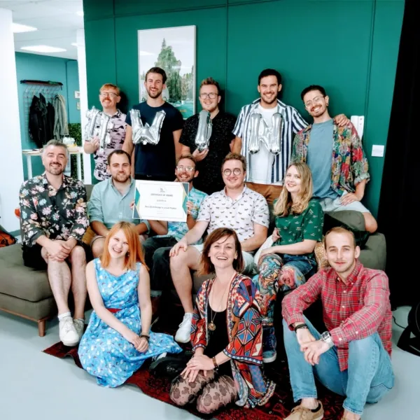 SaaS Awards - group of employees holding Mylar balloons spelling