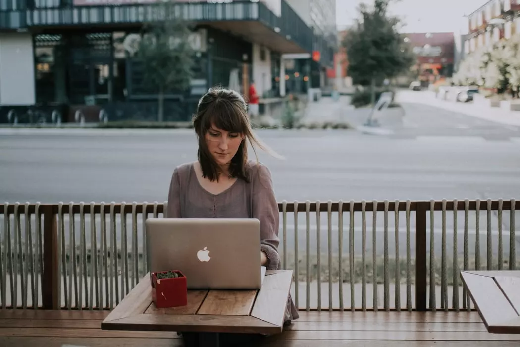 Leadership - woman sitting and working at outdoor table