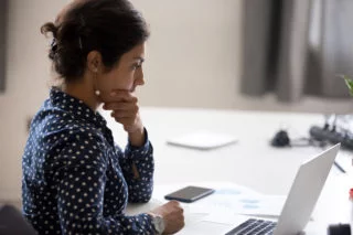 Company culture - focused woman using laptop computer