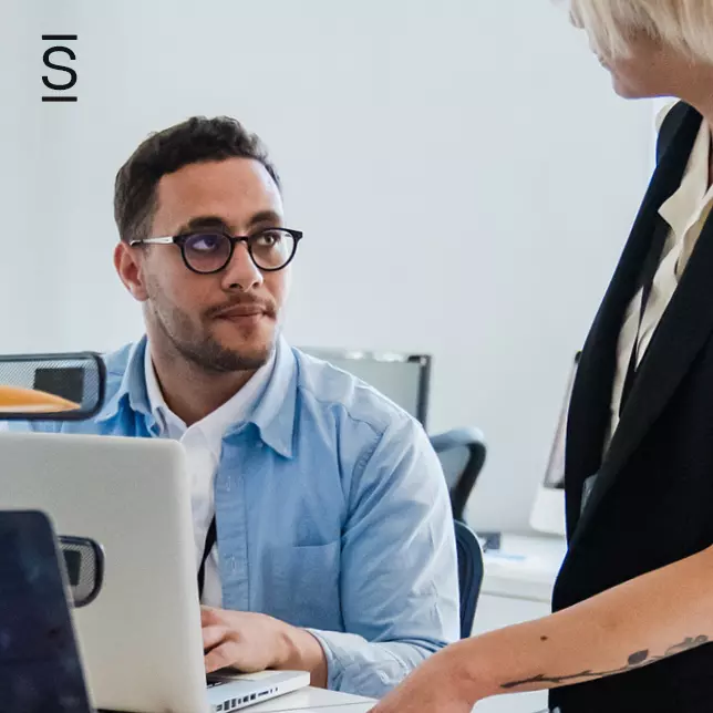 Collaboration ideas - male employee and female employee having a conversation