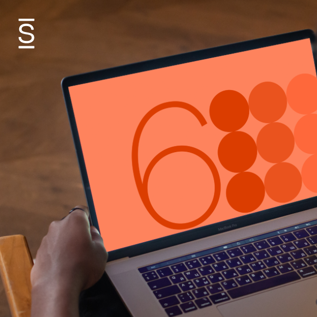 Digital workplace - closeup of a computer screen with an orange background, the number 6, and six dark orange circles