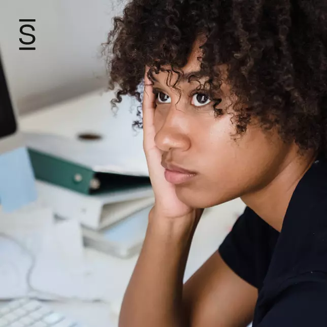 Employee motivation - female employee looking disengaged from her work