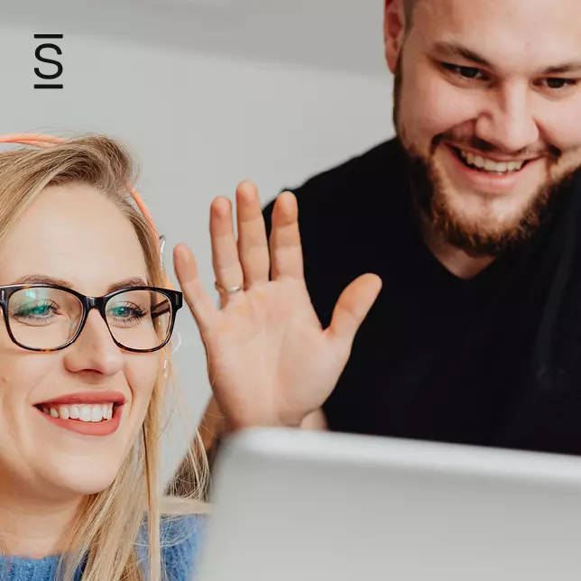 Millennials - male employee and female employee looking at computer screen