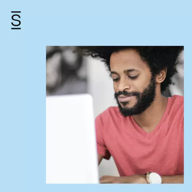 Intranet personalization - man with beard wearing watch looking at laptop computer