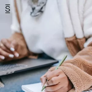 Internal communications best practices - woman writing with pen on notebook