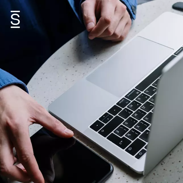 Communication tech stack - employee using laptop computer and smartphone