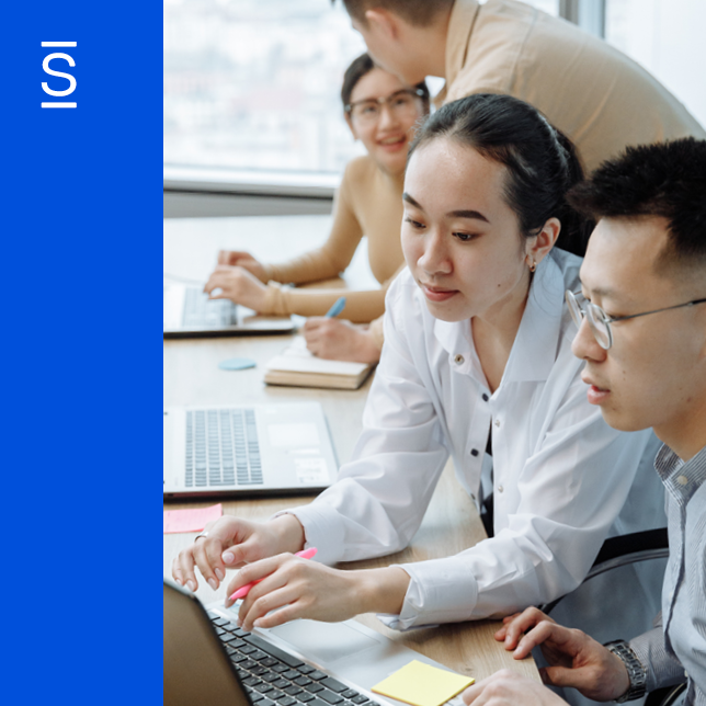 male and female employees using a laptop computer together