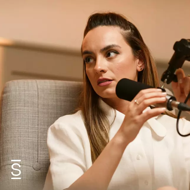 Internal communications - woman looking offscreen while speaking into microphone