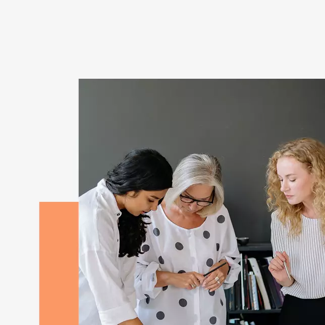 Internal communications - three female employees collaborating on a project