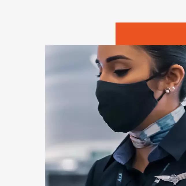 female flight attendant wearing black mask