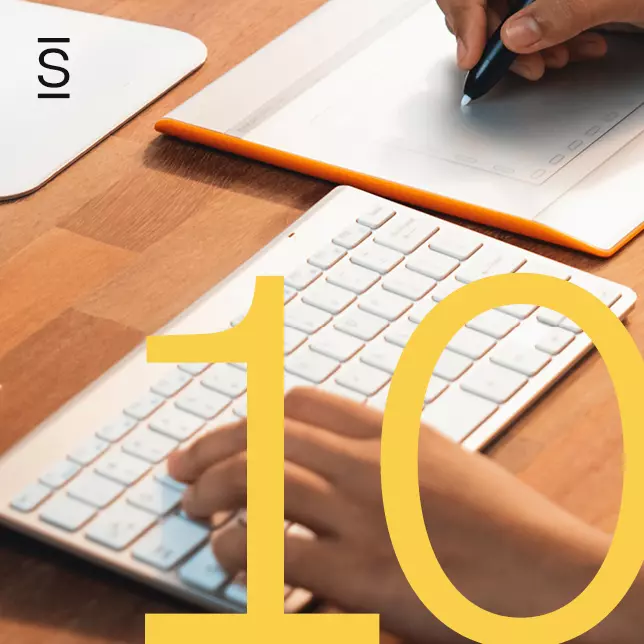 Internal communications free design tools - yellow 10 superimposed over keyboard and touchpad with employee's hand holding a stylus