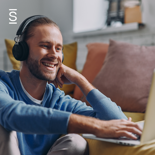 Take conversations digital - man wearing headphones and using laptop