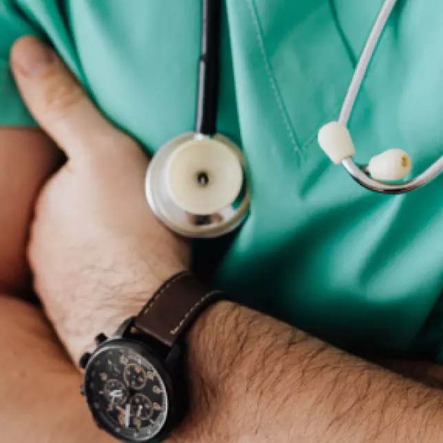 Green Clothing Doctor Arms Crossed Closeup