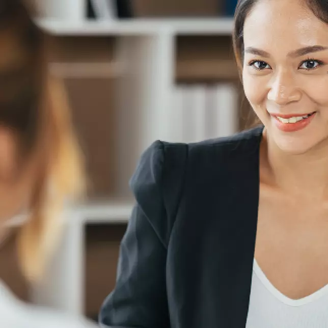 Professional Woman in Blazer Conversing