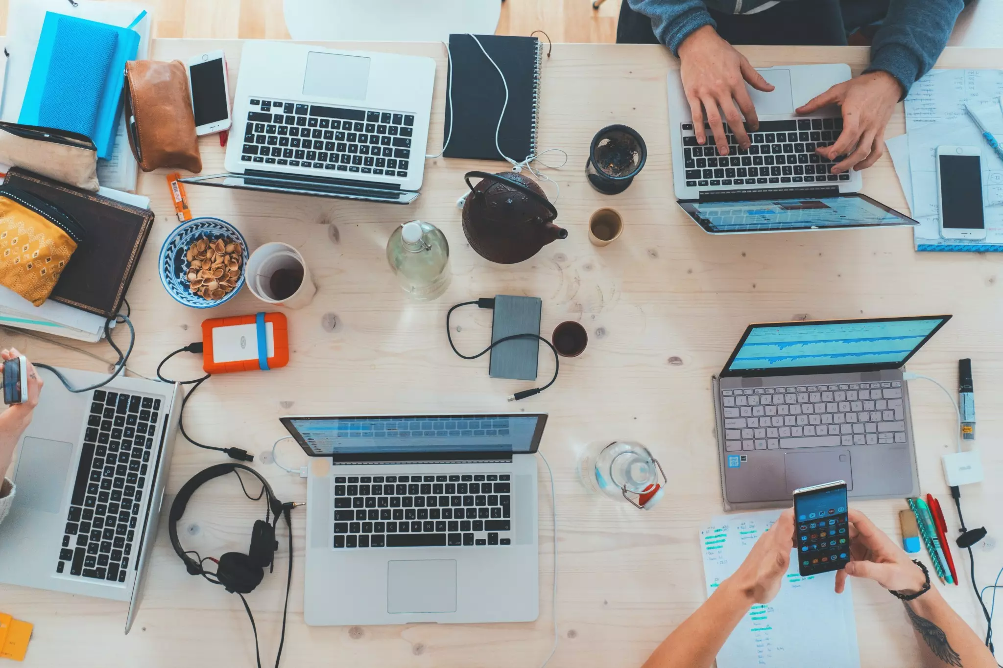 Digital Workplace - group working with laptops and smartphones