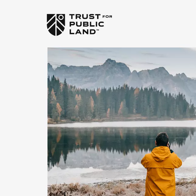 Customer case study - Trust for Public Land logo above photo of man taking pictures of a lake