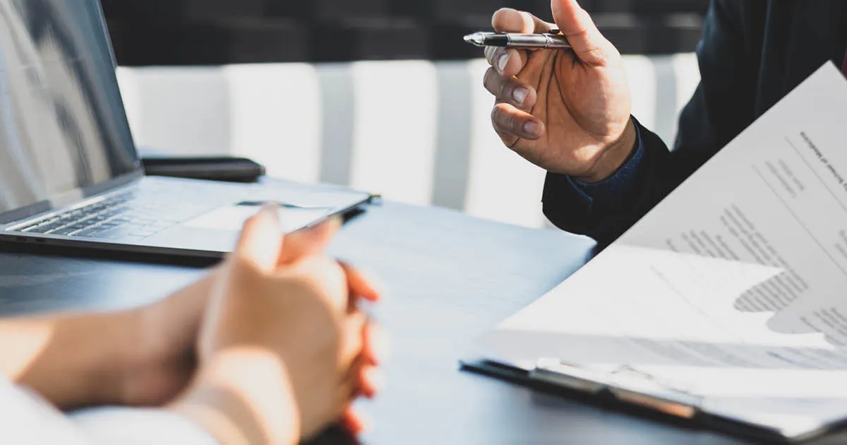 Employee handbook guide - two people looking over pages in a handbook