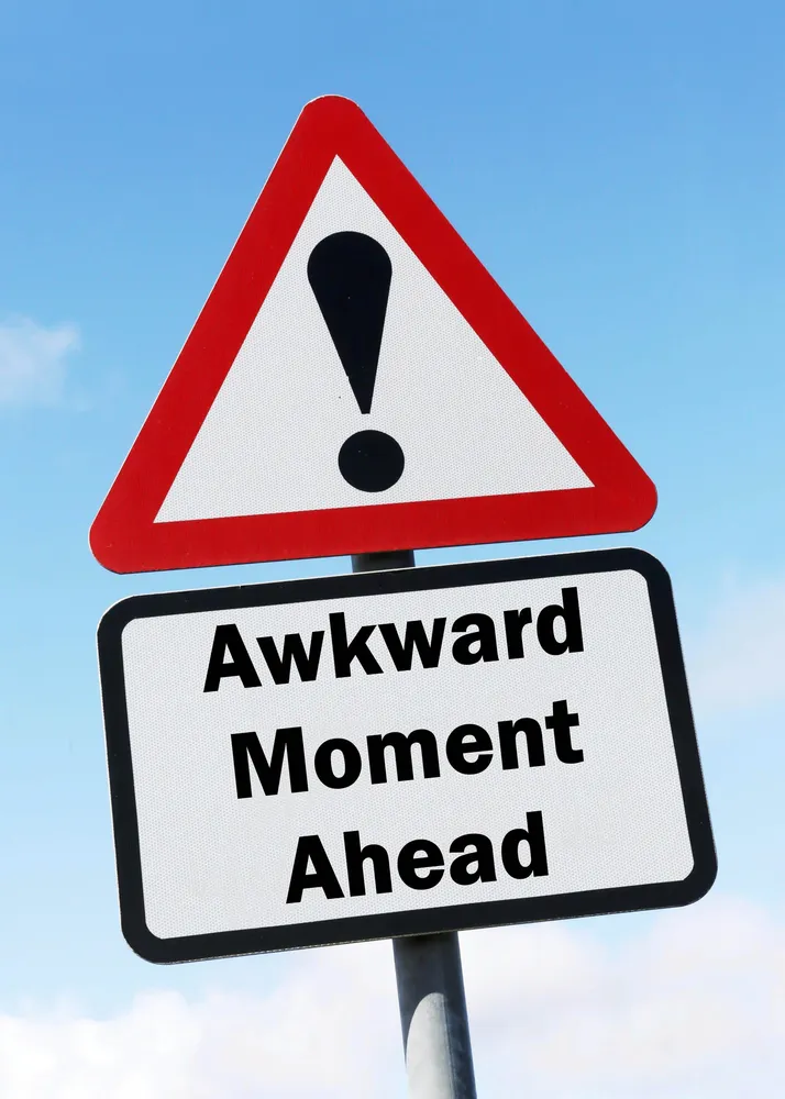 Change management - red & white triangular road sign with warning "Awkward Moment Ahead"